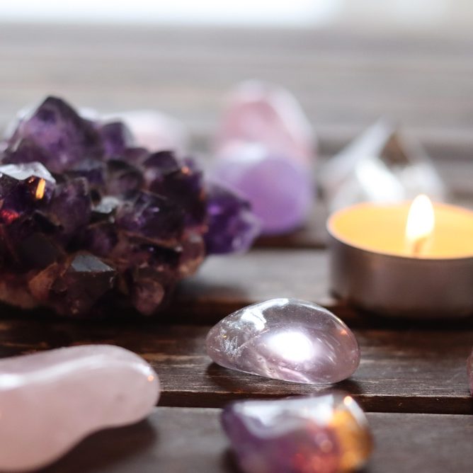Zen,Atmosphere,With,Candles,And,Gemstones.,Quartz,With,Polished,Stones